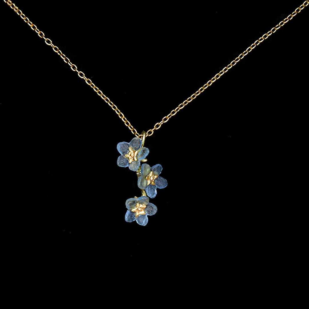 Necklace with blue floral pendant on a black background
