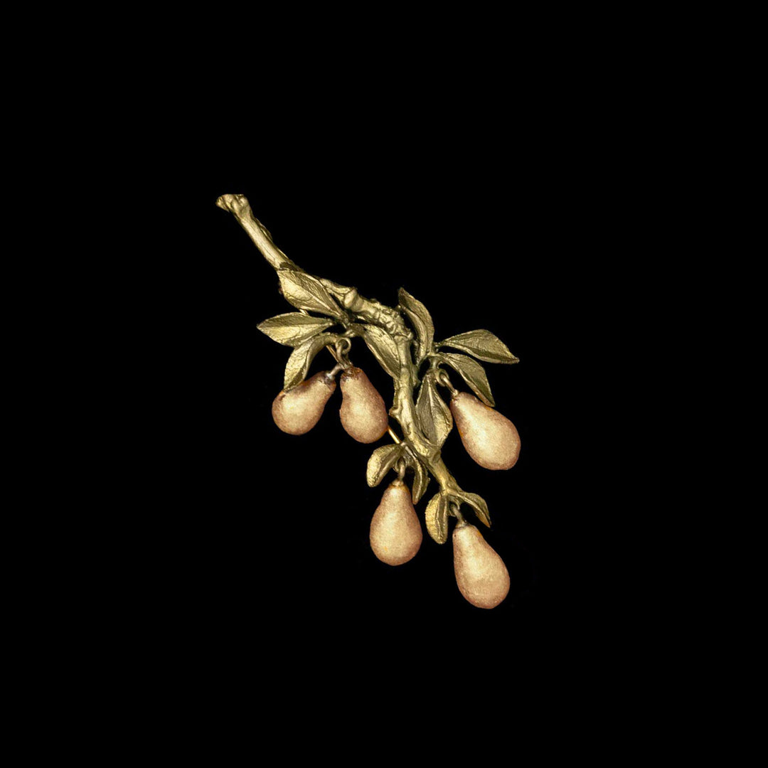 A golden pear brooch with hand patinated bronze and 24kt gold powder coated cast glass pears against a black background.