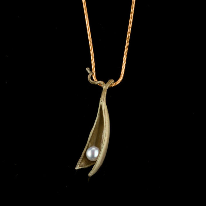 Green pendant with a pearl on a black background