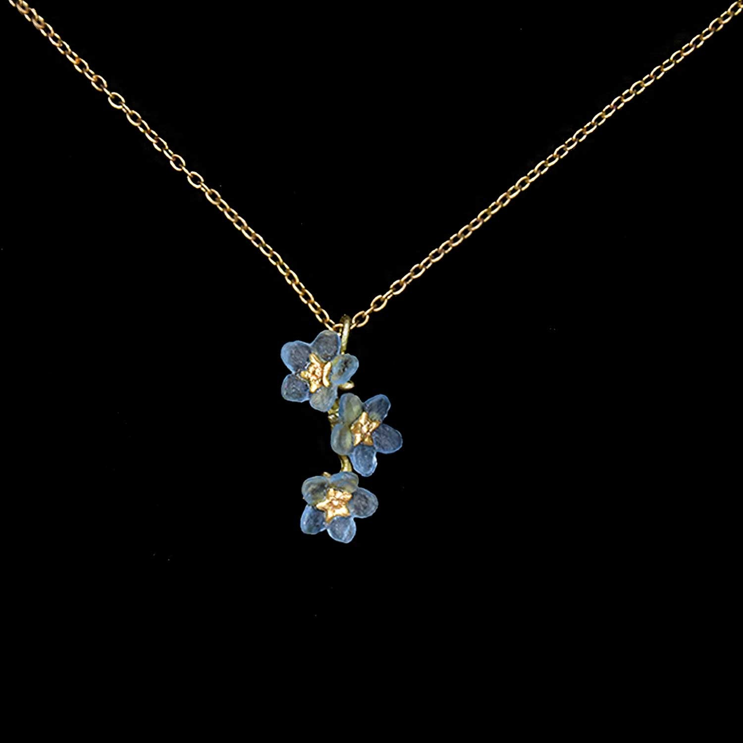 Necklace with blue floral pendant on a black background