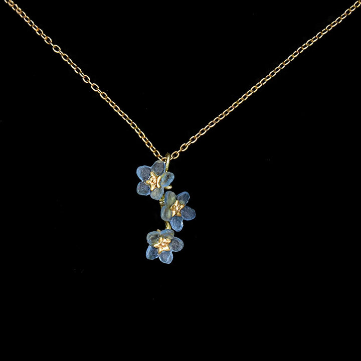 Necklace with blue floral pendant on a black background