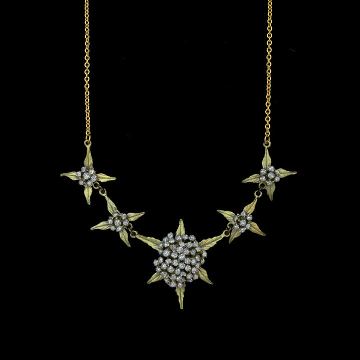 Green leaf necklace with star-shaped pendants on a black background